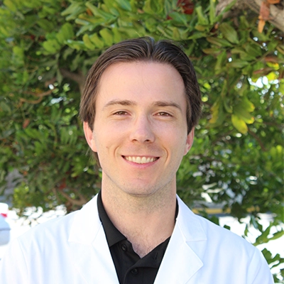 Physical Therapist Jesse Mellema Smiling In Lab Coat
