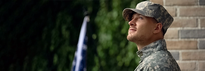 Man In Army Fatigues Looking Off In The Distance